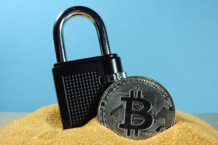 A padlock and a bitcoin signifying security in the bitcoin blockchain